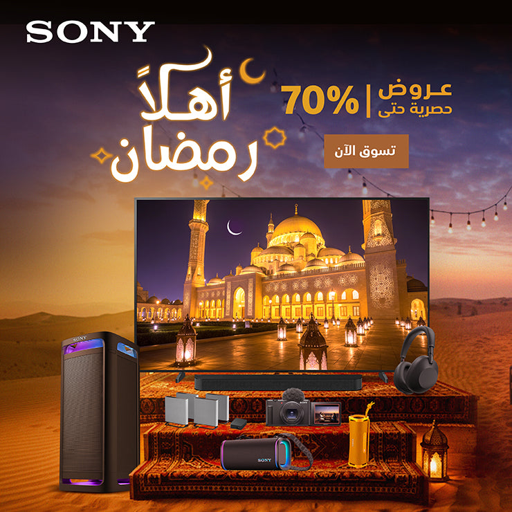 Sony electronic devices on a table with a mosque image on a screen, set against a desert landscape with a moonlit sky.
